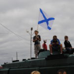 Маленькие дети наблюдали за происходящим забравшись на танк